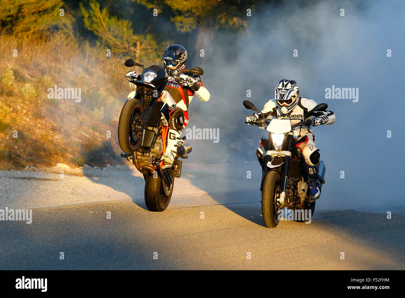 Motorräder, Funbikes, Husquarna Nuda 900R und KTM 990 SMC, bewegen auf Landstraße, Wheelie und Burnout, Stockfoto
