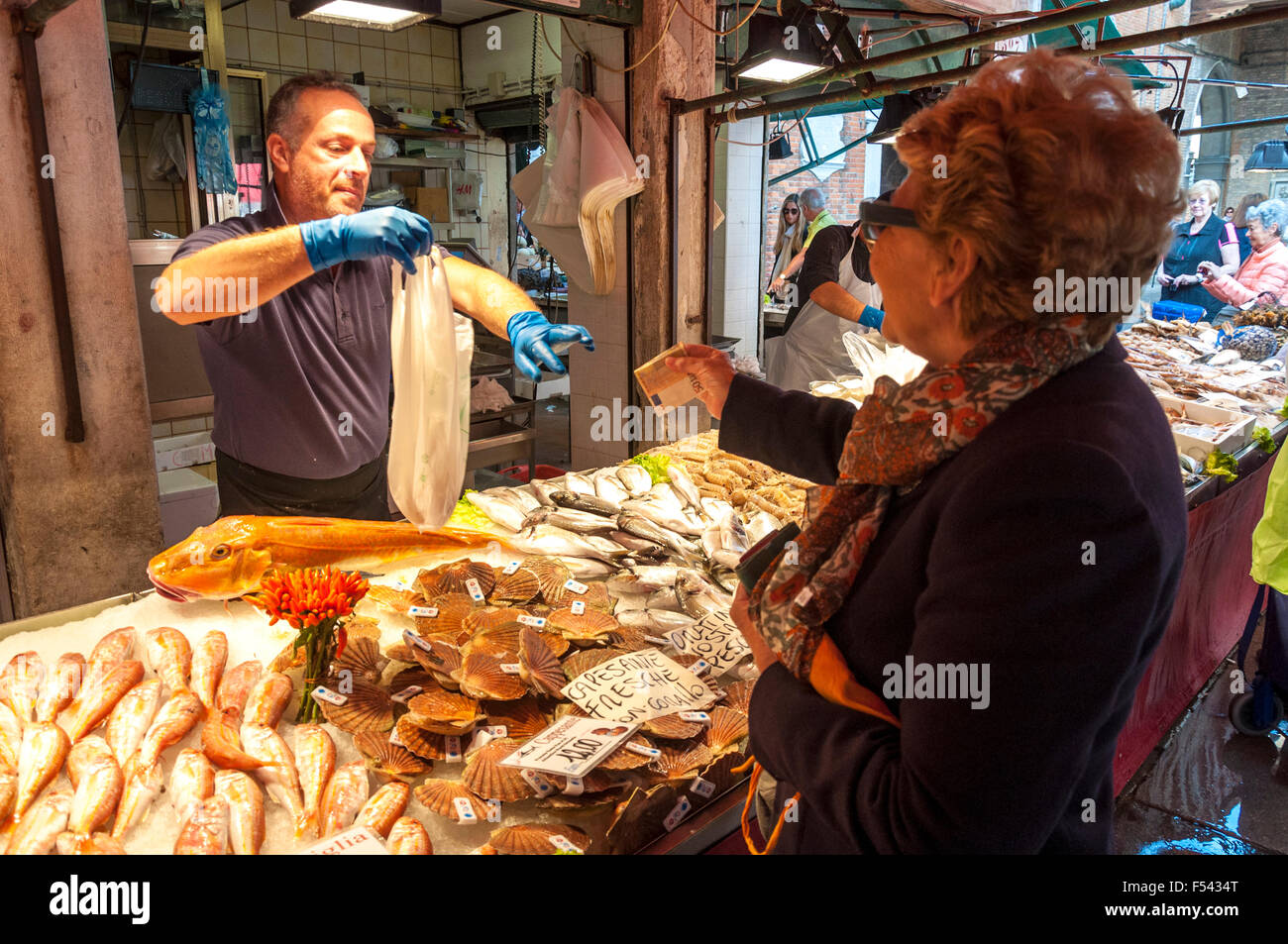 Frau shopping für Fisch in der Pescheria Fisch Markt der Mercato di Rialto, Venedig, Italien Stockfoto