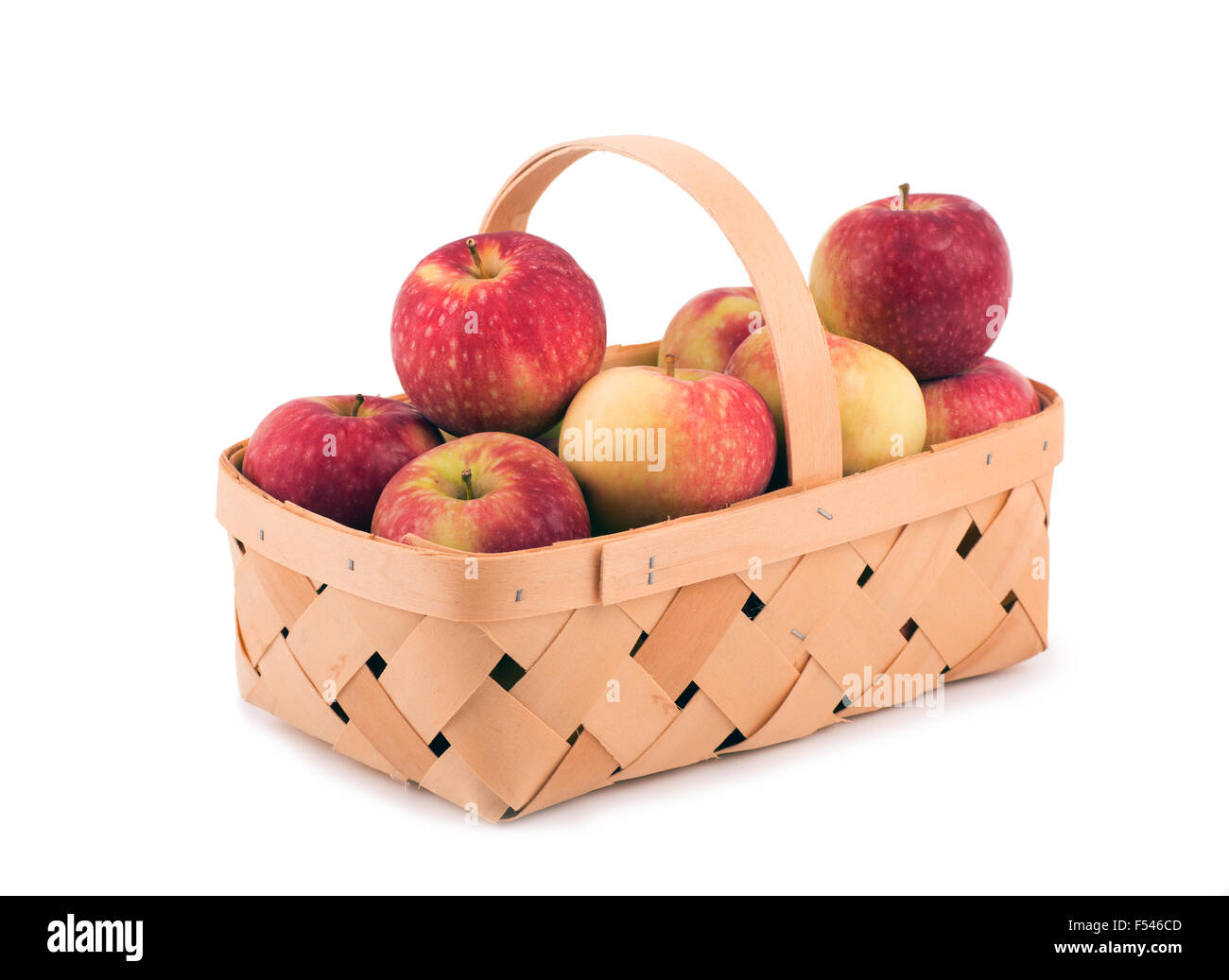 Äpfel in einem hölzernen Korb auf weiß Stockfoto