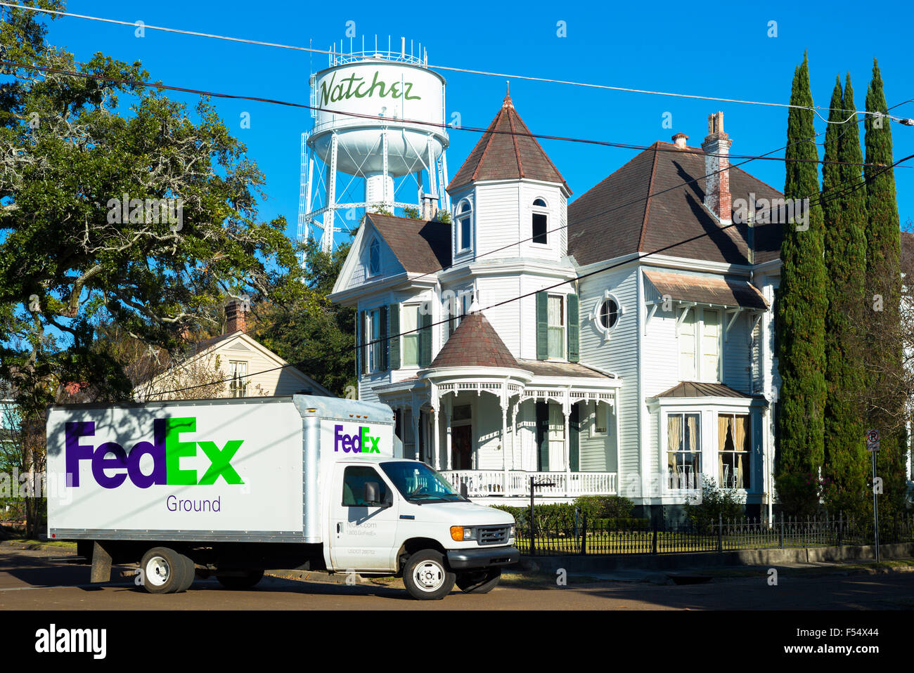 Amerikanische Szene - Wasserturm und FedEx LKW durch ein typisches Herrenhaus in Natchez, Mississippi, Vereinigte Staaten Stockfoto