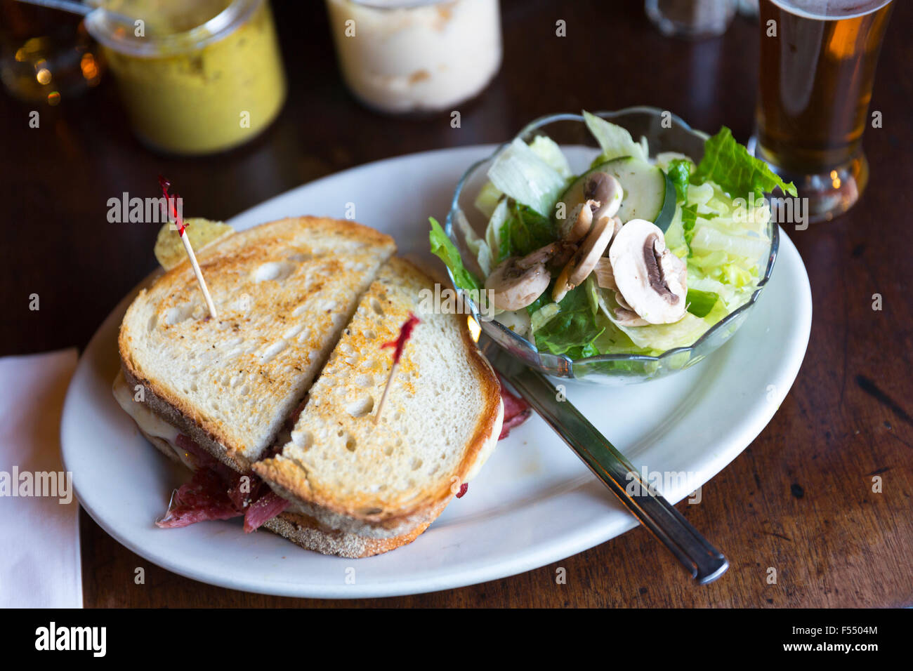 Riesige Deli Brot Sandwich mit Senf und Salat in bar Diner Restaurant in Soho, New York, USA Stockfoto