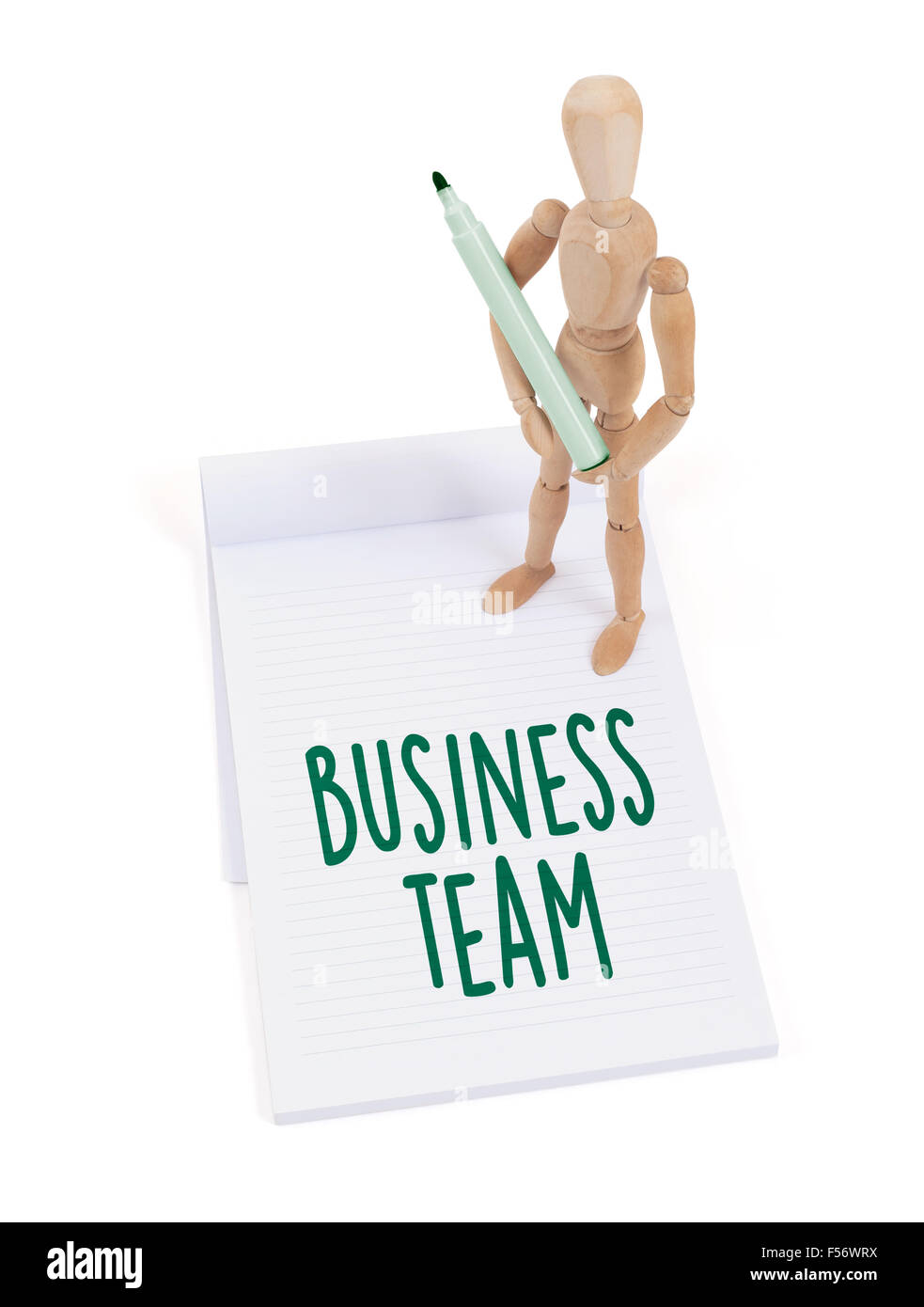 Hölzerne Puppe in einem Scrapbook - Business-Team schreiben Stockfoto