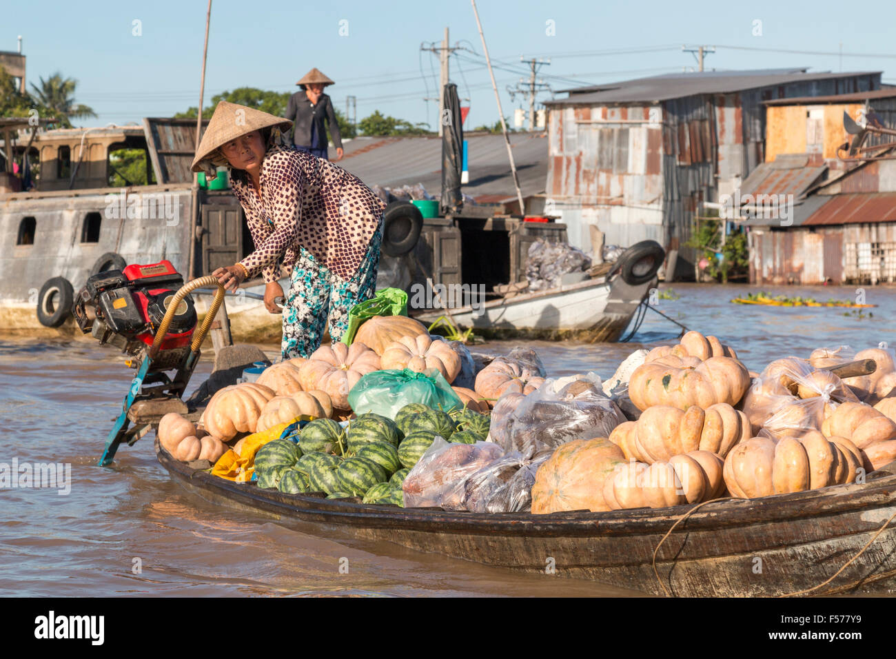 vietnamesische Boote und Männer Arbeitnehmerinnen bei Cai Rang schwimmende Märkte kaufen verkaufen frisches Obst, den Futternapf von Vietnam Stockfoto