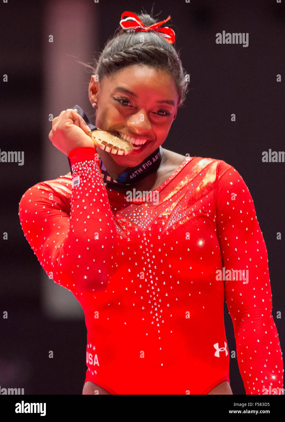 Glasgow, Schottland. 29. Oktober 2015. Abb. Künstlerische Gymnastik-Weltmeisterschaften. Tag 7. Simone BILES (USA) 2014 World Championships Team Goldmedaillengewinner, Mehrkampf-Olympiasieger, Tresor Silber Medallist, Goldmedaillengewinner Schwebebalken und Boden Goldmedaillengewinner beißen ihre 2015 Mehrkampf-Gold-Medaille nach der Siegerehrung. Bildnachweis: Aktion Plus Sport/Alamy Live-Nachrichten Stockfoto