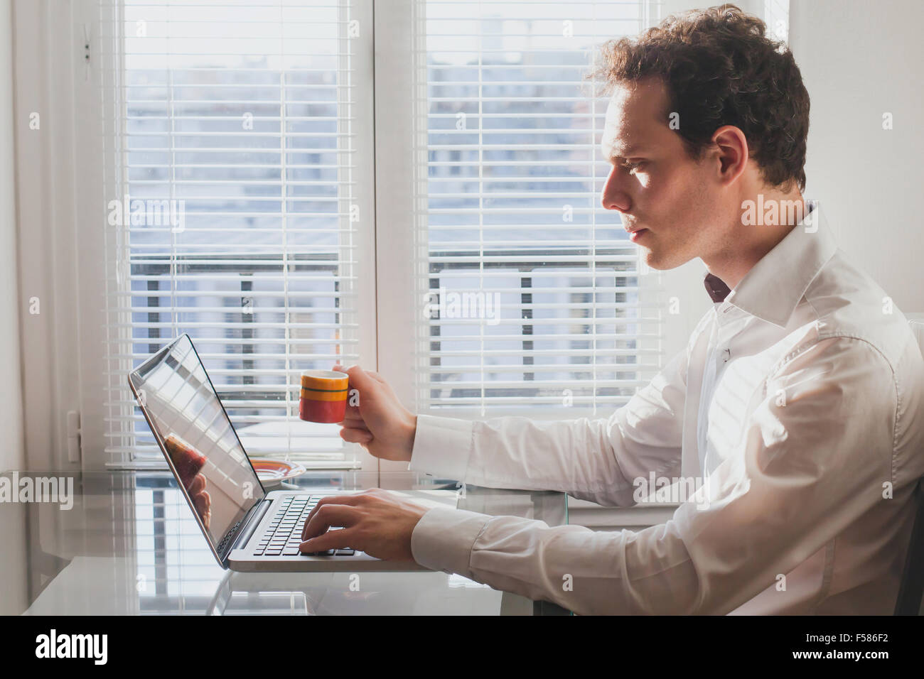 Geschäftsmann, Lesen von e-Mails im Büro mit Kaffee Stockfoto