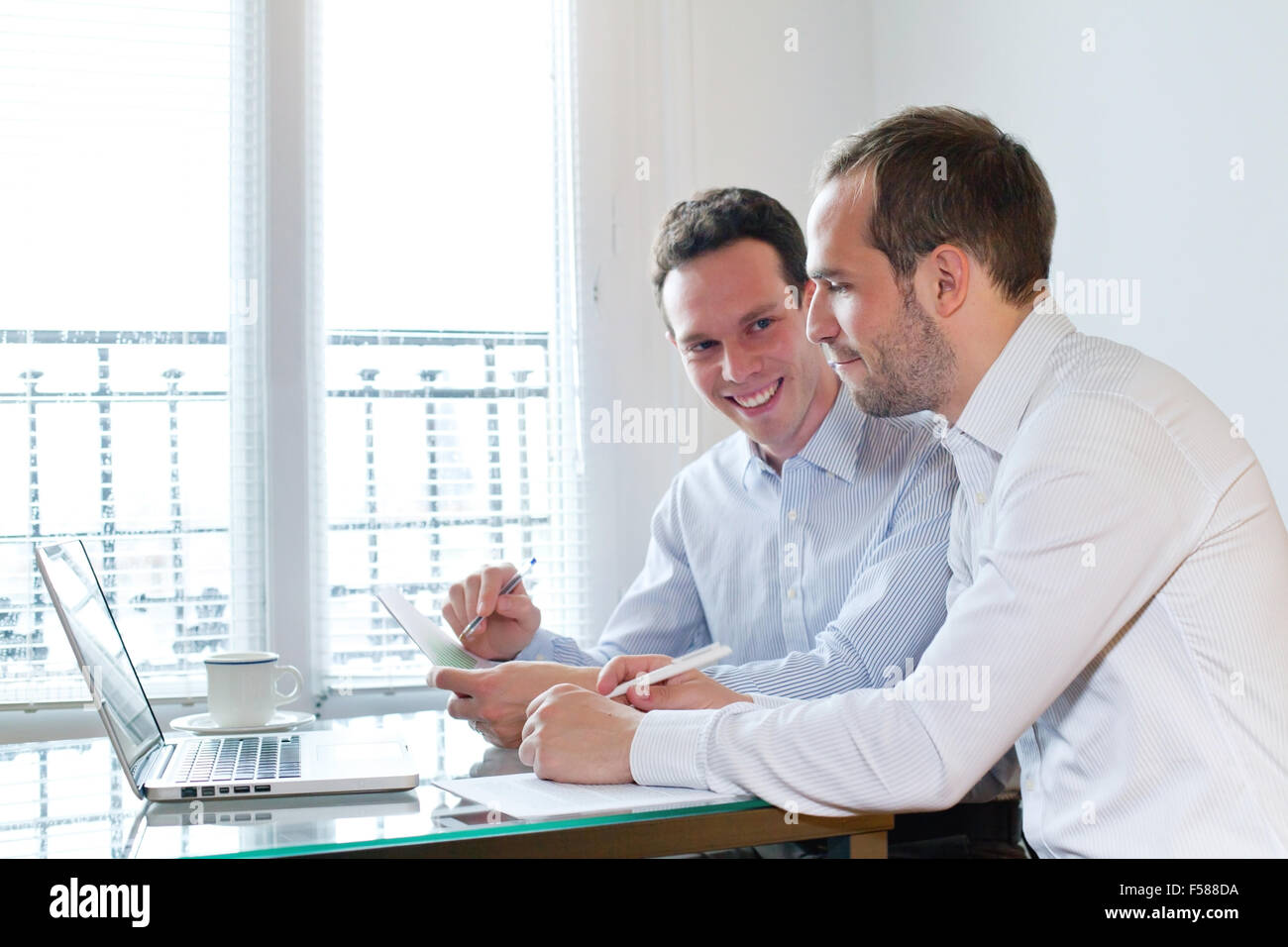 zwei Lächeln glücklich Geschäftsleute arbeiten am Projekt im Büro Stockfoto