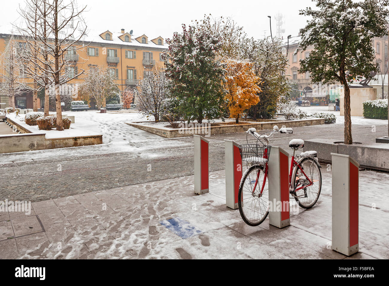 Städtischen Fahrrad- und Stadt Quadrat auf Grund unter dem Schnee in Alba, Piemont, Norditalien. Stockfoto