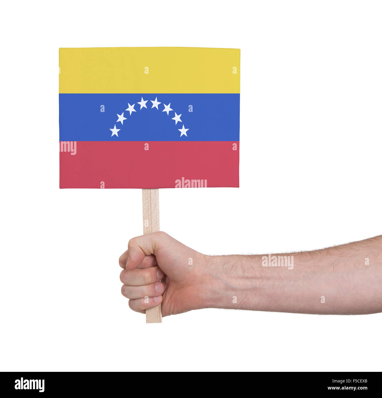 Hand, die kleine Karte, isoliert auf weiss - Flagge Venezuelas Stockfoto