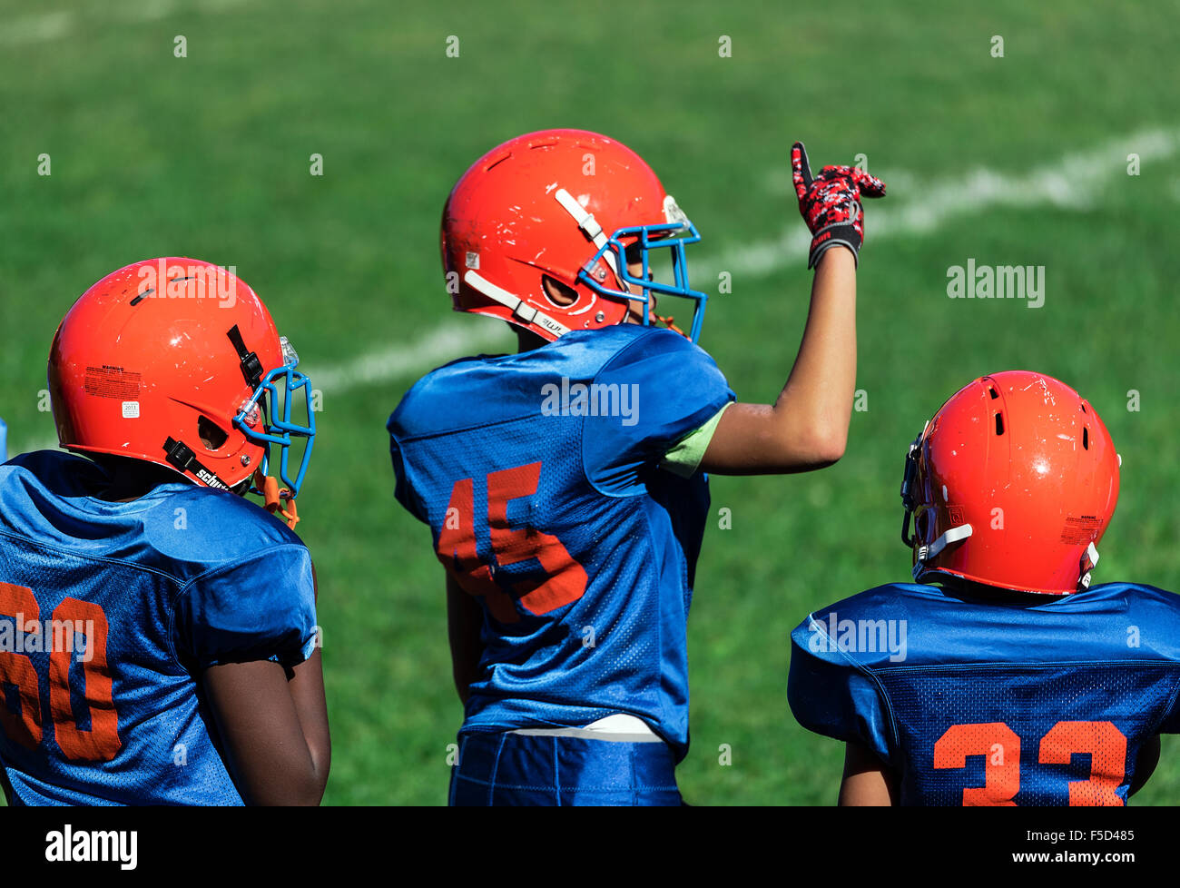 Junge Burschen an der Sideline eines Fußballspiels Pop Warner, USA Stockfoto