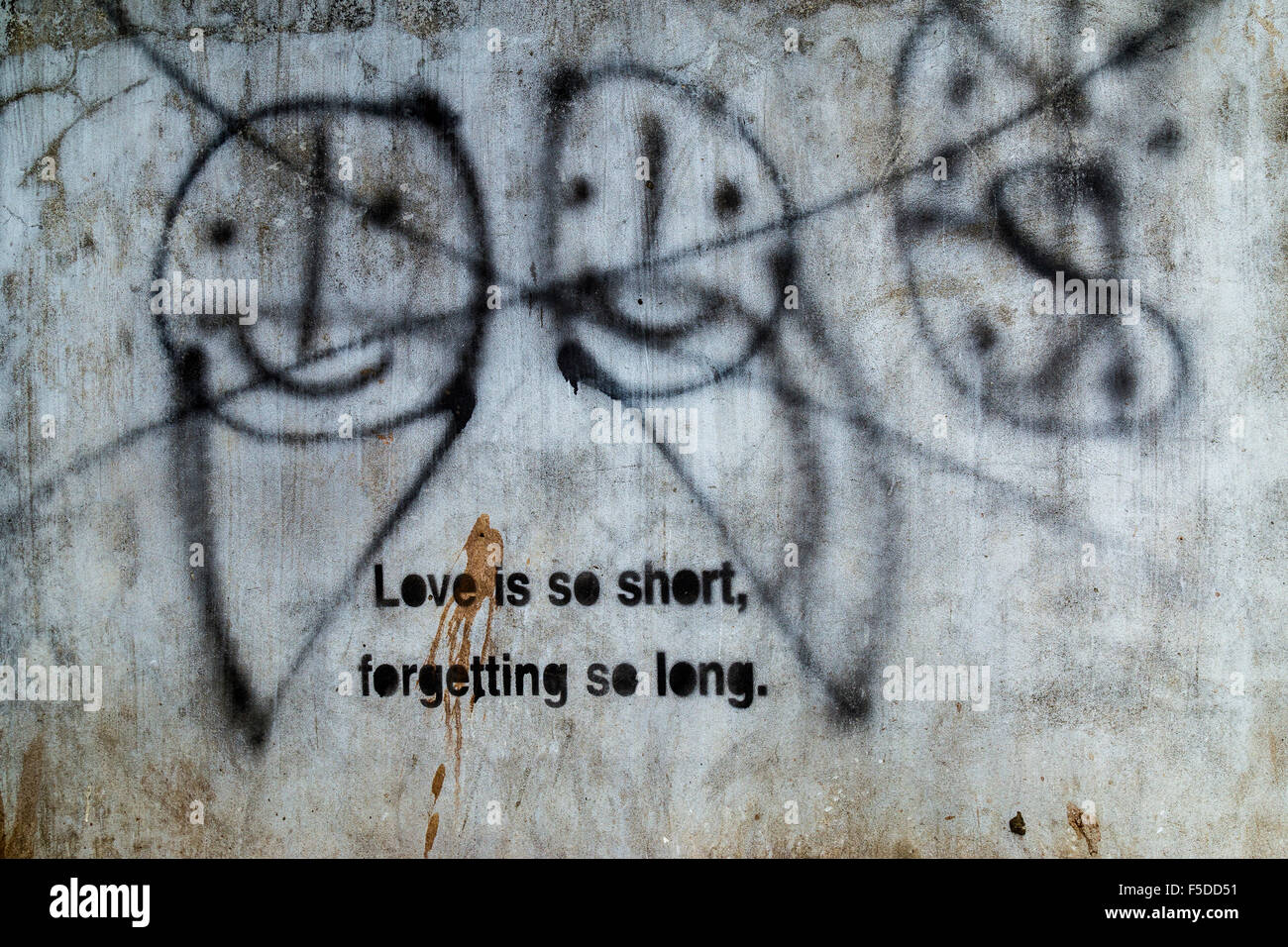 Graffiti an einer Wand in Yangon Myanmar, mit Smiley Gesichter durchgestrichen und Schablone Motto, ist Liebe so kurz zu vergessen, so lange Stockfoto
