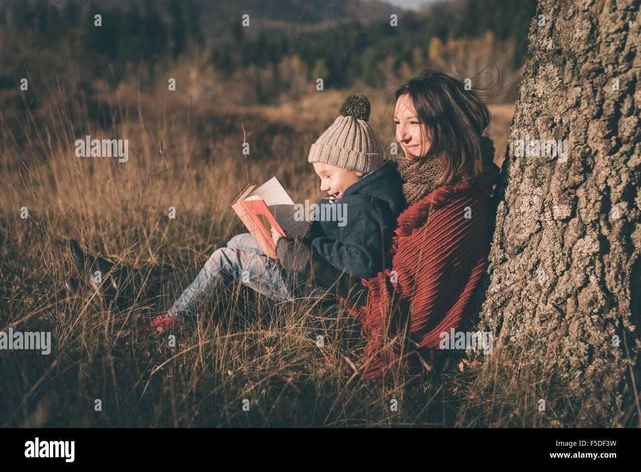 Mutter und Sohn in der Natur. Lesebuch und lächelnd. Stockfoto