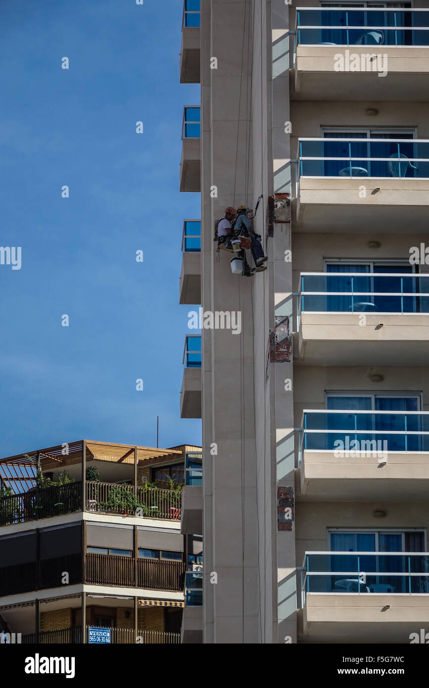 Handwerker Reparatur gefährlich zerbröckelnden Beton facias auf hohe Gebäude in Benidorm, Costa Blanca, Spanien Stockfoto