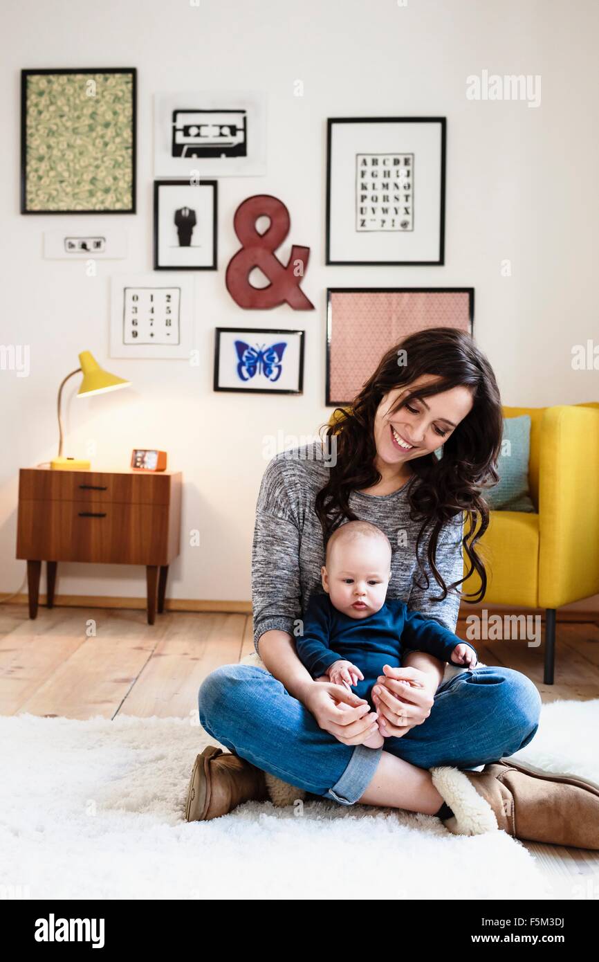 Mutter mit Baby Sohn auf Runde im Wohnzimmer Stockfoto