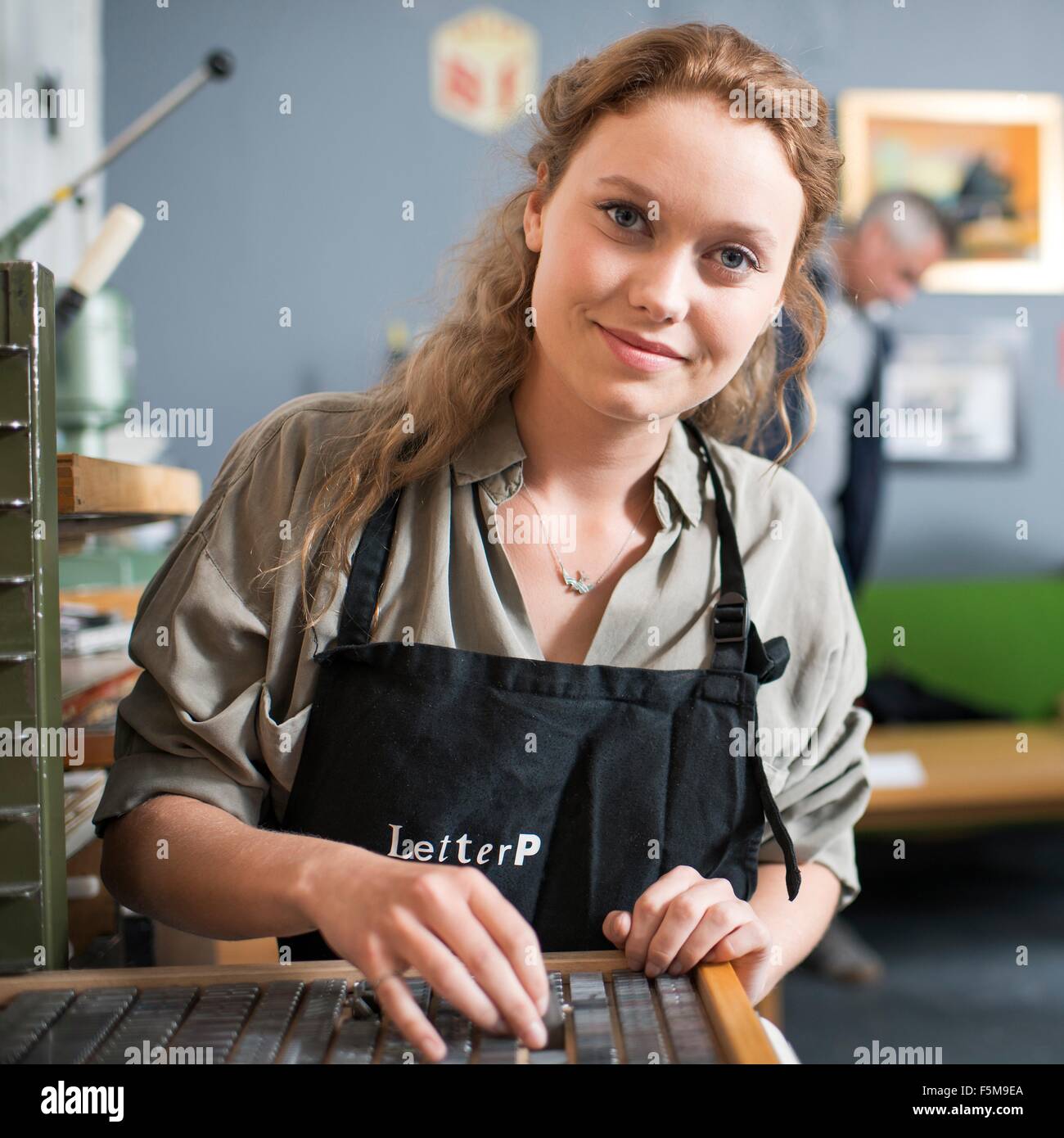 Porträt der jungen Frau mit Buchdruck Tablett in Druckwerkstatt Stockfoto