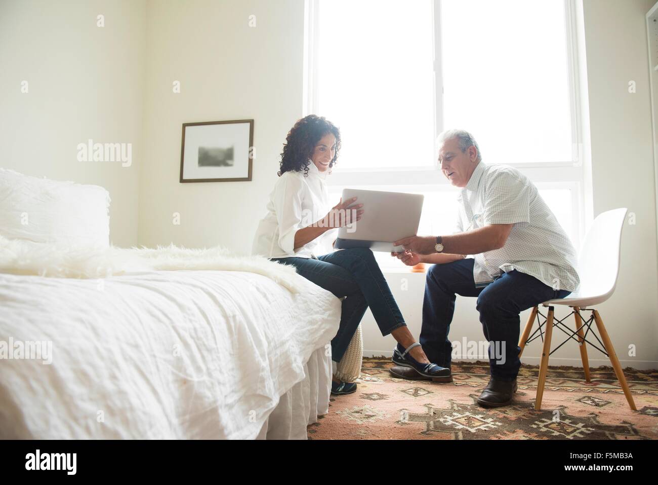 Reife älteres paar Blick auf Laptop im Schlafzimmer Stockfoto