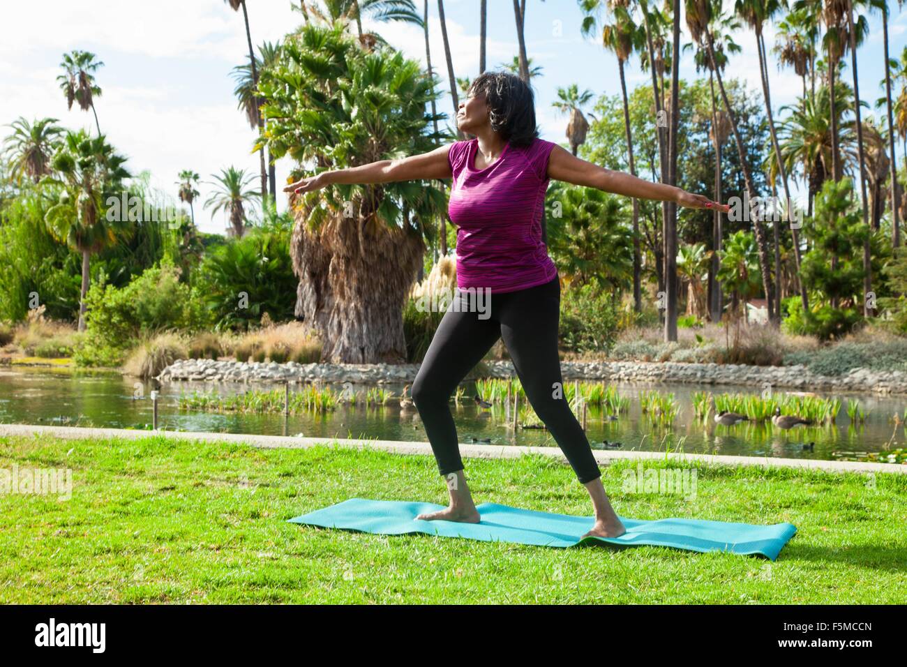 Ältere Frau beim Yoga im park Stockfoto