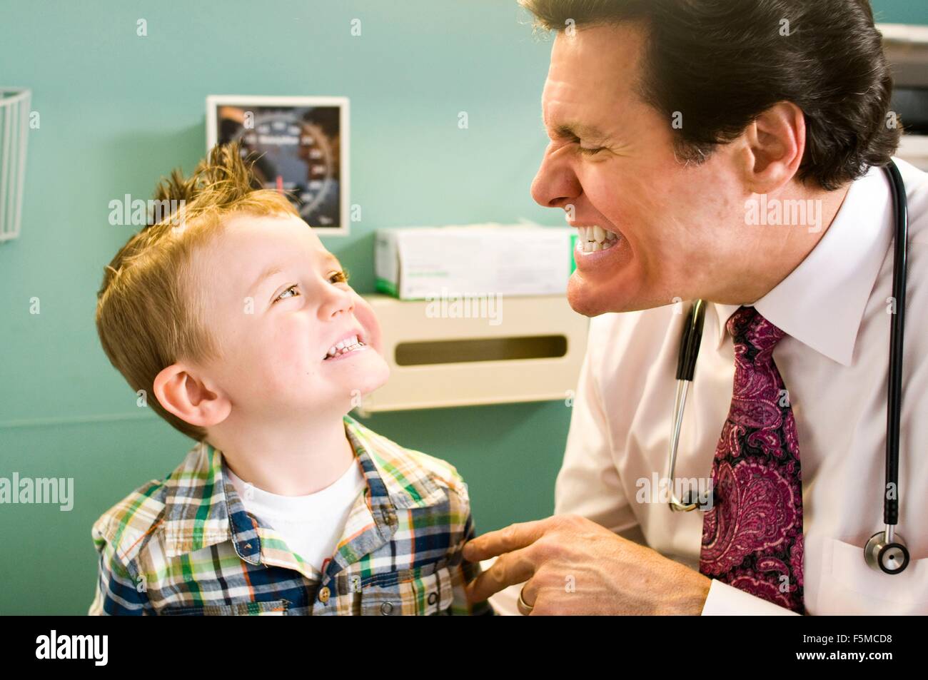 Männlichen Arzt Blick auf kleinen Jungen Zähne Stockfoto