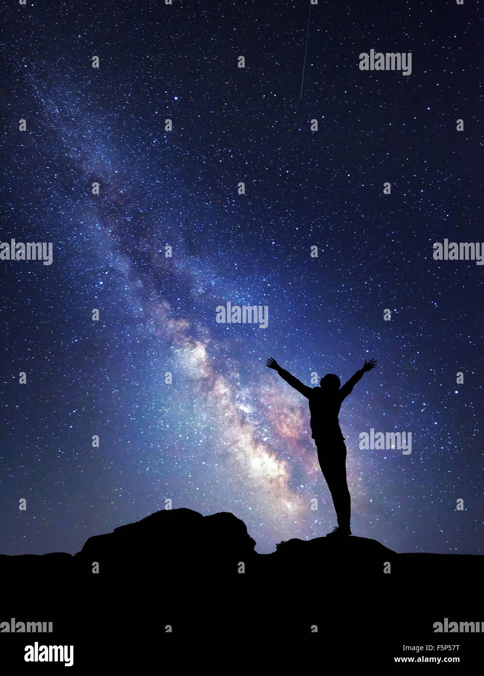 Milky Way. Nachthimmel mit Sternen und Silhouette einer Frau, Yoga zu praktizieren. Stockfoto