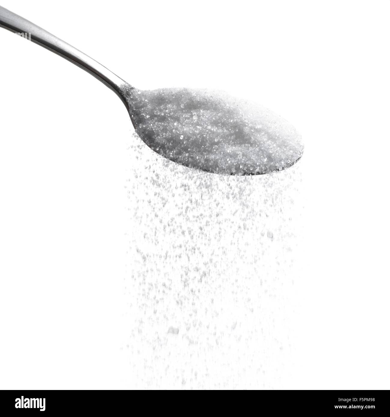 Zucker auf einem Löffel vor einem weißen Hintergrund. Stockfoto