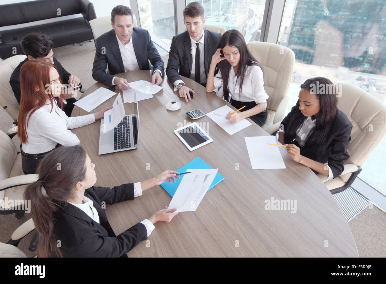 Business-Meeting der unterschiedlichsten Menschen rund um den Tisch Stockfoto