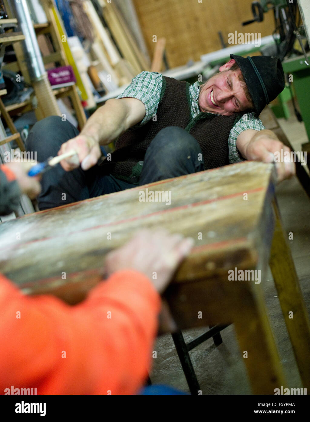 Ohlstadt, Deutschland. 22. Oktober 2015. Finger ziehen Champion Josef Utzschneider (R) übt seine Finger ziehen Fähigkeiten in die Tischlerei seines Bruders in Ohlstadt, Deutschland, 22. Oktober 2015. Utzschneider verlor nie einen Wettbewerb seit 2007. Foto: Angelika Warmuth/Dpa/Alamy Live News Stockfoto