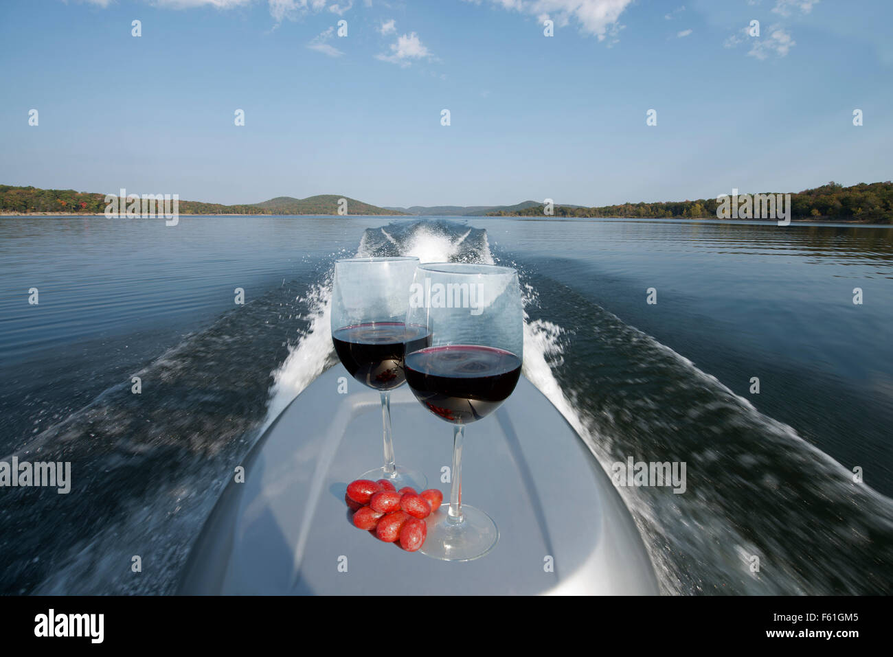 Zwei Gläser rote Wein Gleichgewicht auf einem Motorboot auf gläsernen ruhigen Wasser von einem Boot am frühen Abend fahren; Table Rock Lake, Miss Stockfoto