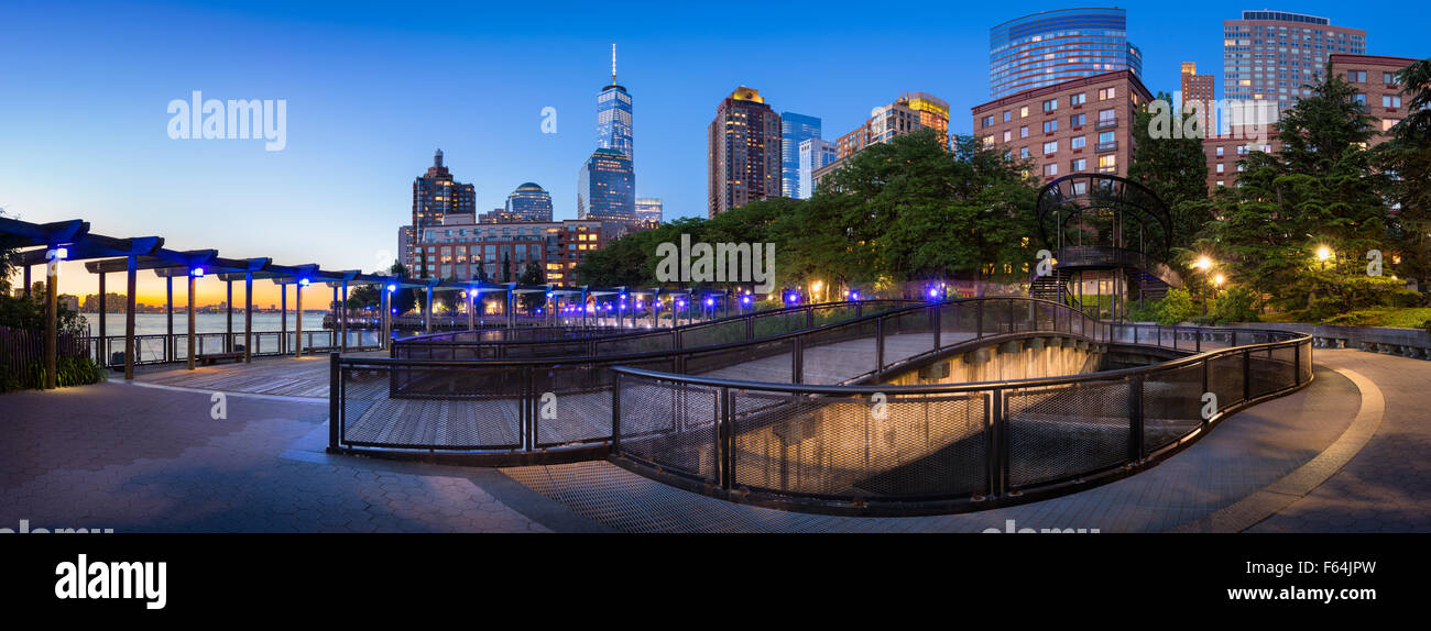 Hudson River Park mit Wolkenkratzern im Manhattan Financial District. Blick auf Lower Manhattan bei Sonnenuntergang mit One World Trade Center vom South Cove Park Stockfoto