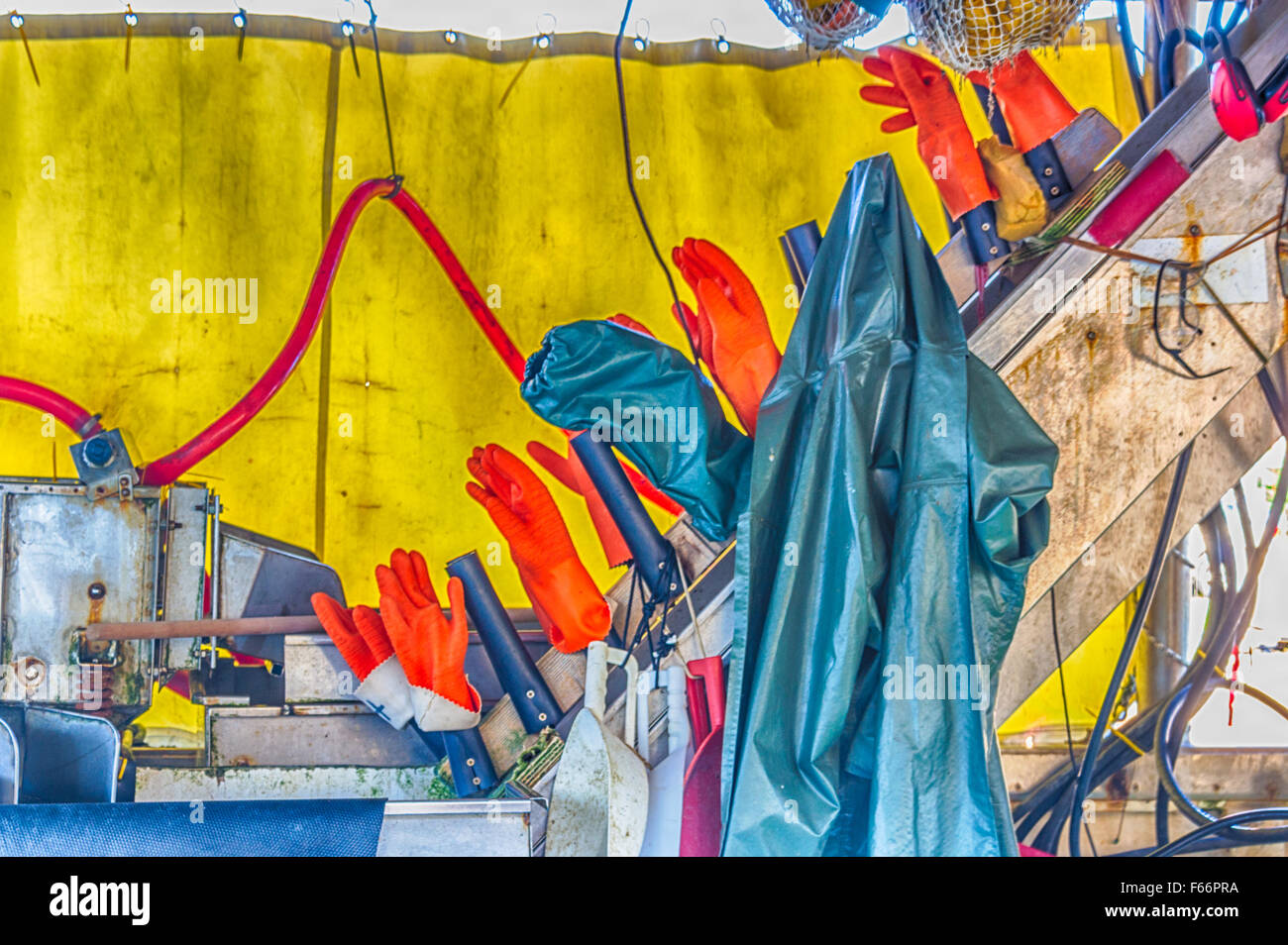 Fischer orange Handschuhe zum Trocknen auf einem Boot gehängt Stockfoto