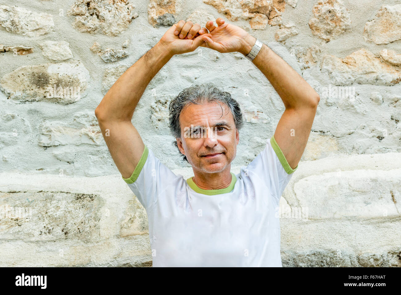 Mann mittleren Alters in Sportbekleidung bei einem Besuch in den alten Gassen der mittelalterlichen Stadt in Vico del Gargano in Italien, bekannt als das Dorf der Liebe Zeit suspendiert Stockfoto