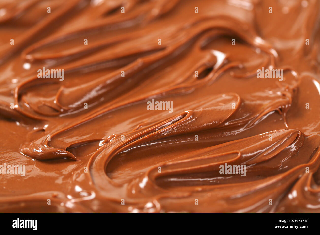 Detail der geschmolzenen Schokolade Verbreitung Hintergründe Stockfoto