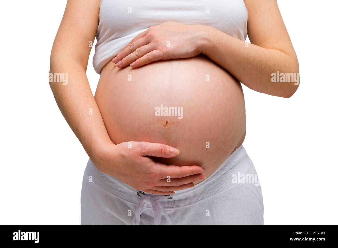 Schwangere Frauen in weißen Lounge tragen isoliert auf weiss Stockfoto