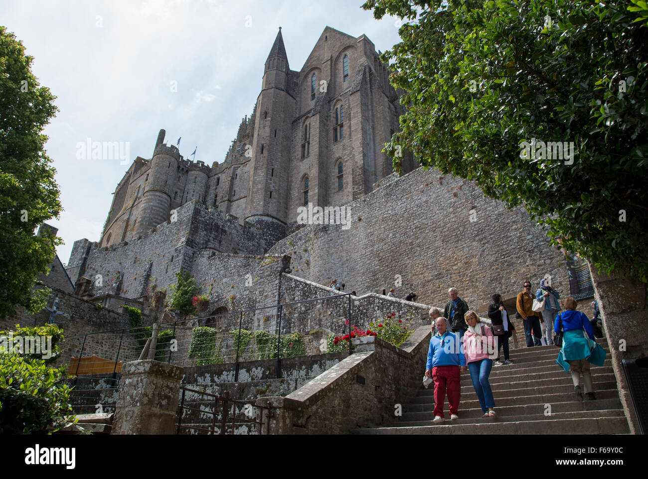Touristen gehen die Schritte am Mont Saint-Michel-Insel-Gemeinde an der Mündung des Flusses Cousenon, in der Nähe von Avranches, Normandie Frankreich. Stockfoto