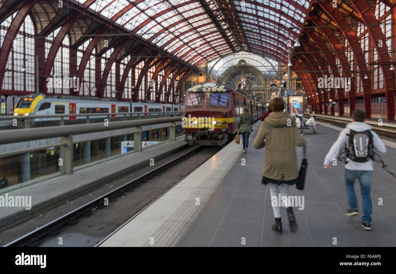 Mehrere Jugendliche zornbebend zu einen Zug, dessen Abreise bevorsteht. Oberirdischen Bahnhof Antwerpen-Plattform. Stockfoto