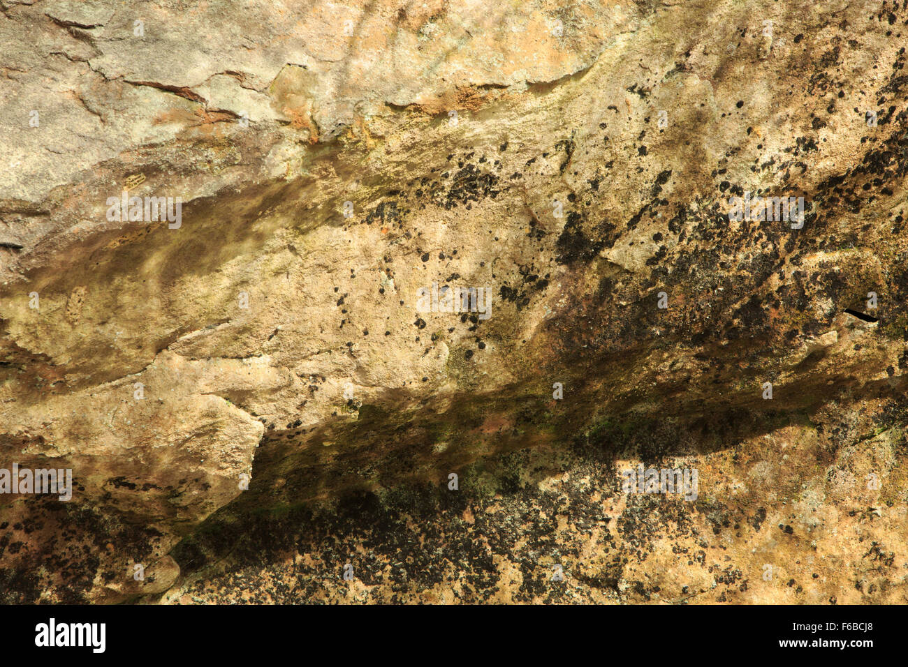 Sandsteinmauer mit Reflexionen vom Plätschern des Wassers unten Stockfoto