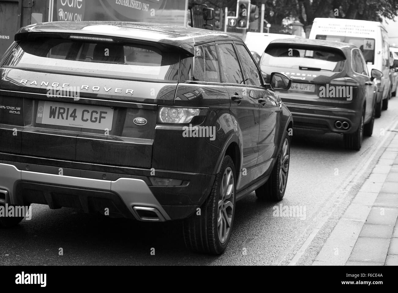 Moderne schwarz 4 x 4 Fahrzeuge, SUV im Stadtverkehr, Land Rover Range Rover und Porsche Stockfoto