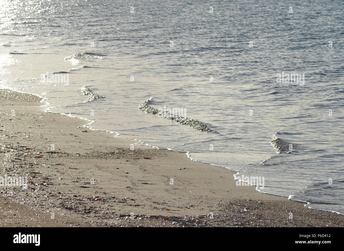 Wasser am Strand in der Morgensonne Stockfoto
