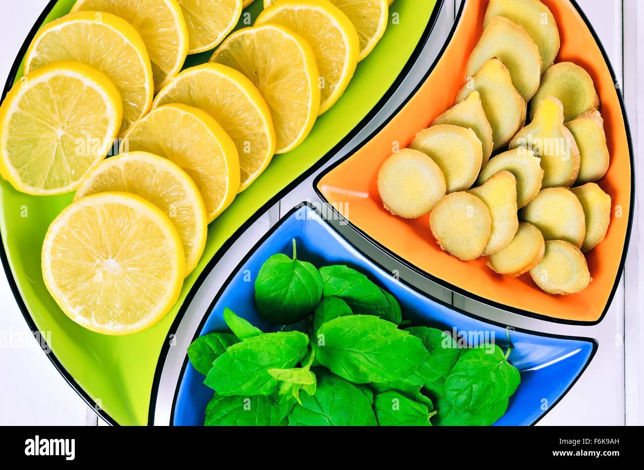 Zitrone, Ingwer und Minze Blätter in bunten Schalen. Stockfoto