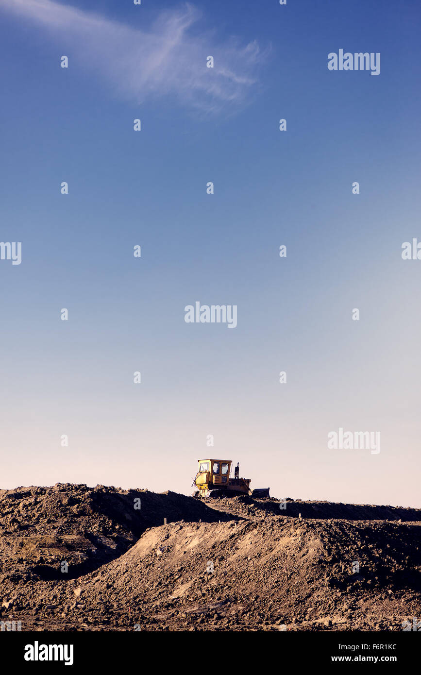 Rad-Lader-Bagger am Eathmoving arbeitet in Baustelle, Retro-getönten mit Textfreiraum Stockfoto