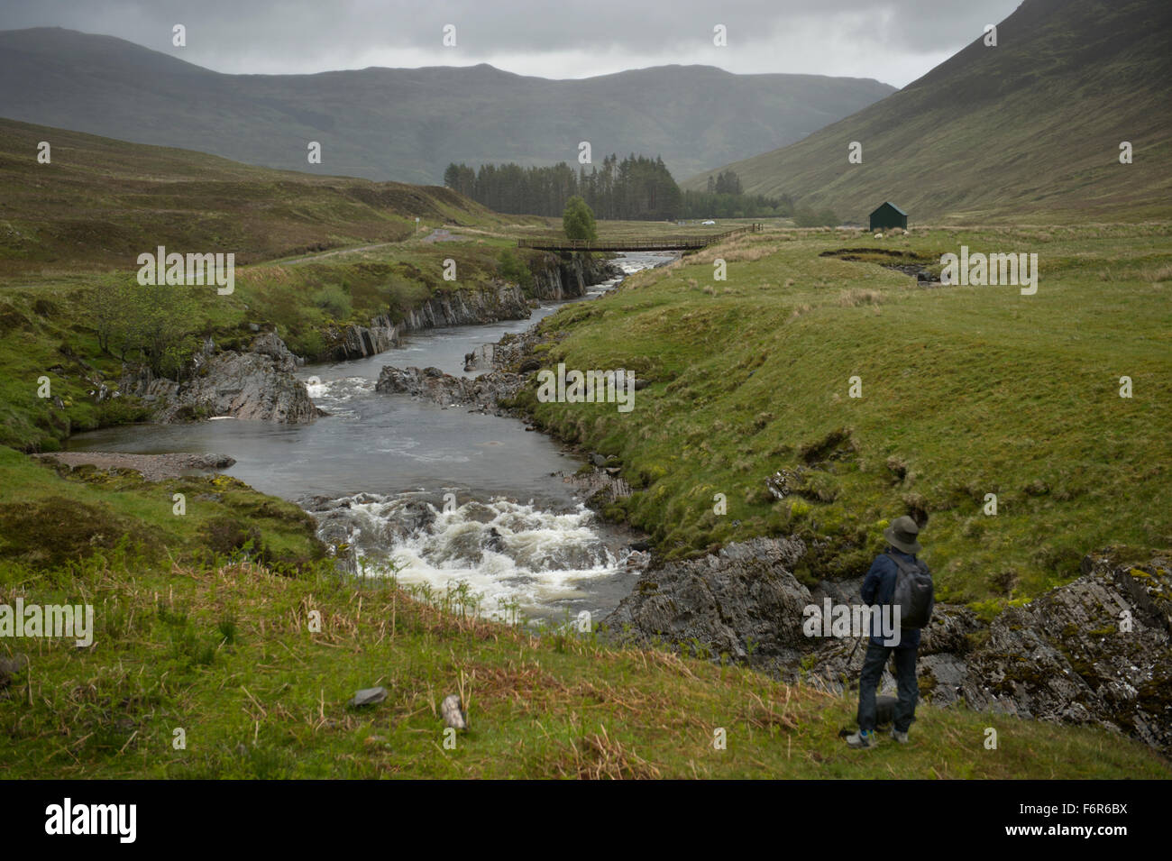 Ein einsamer Wanderer blickte Glen Roy und seinen Fluss Roy mit Hügeln und Bergen und die geologischen Parallelstraßen features Stockfoto