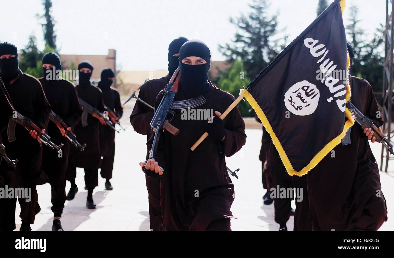 Islamischer Staat im Irak und der Levante-Propaganda-Foto zeigt maskierten Kämpfer hält die schwarze ISIS Banner von Muhammad. Stockfoto