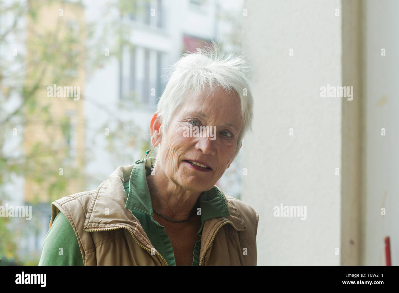 Porträt von weißen Haaren senior Frau vor einem Fenster Stockfoto