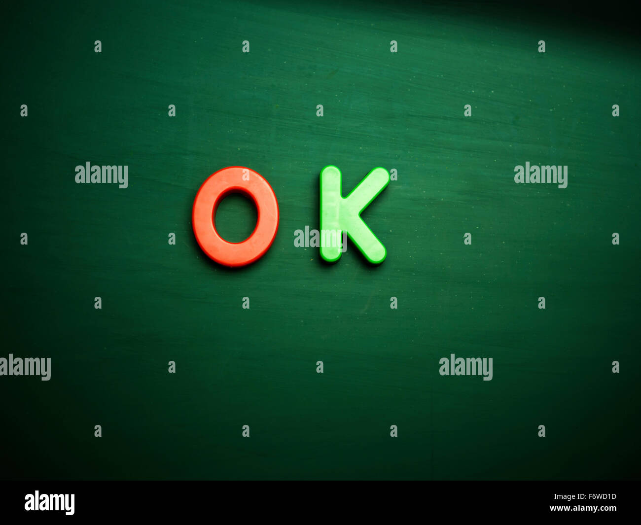 OK oder OK Konzept in bunten Buchstaben isoliert auf leere Tafel Stockfoto