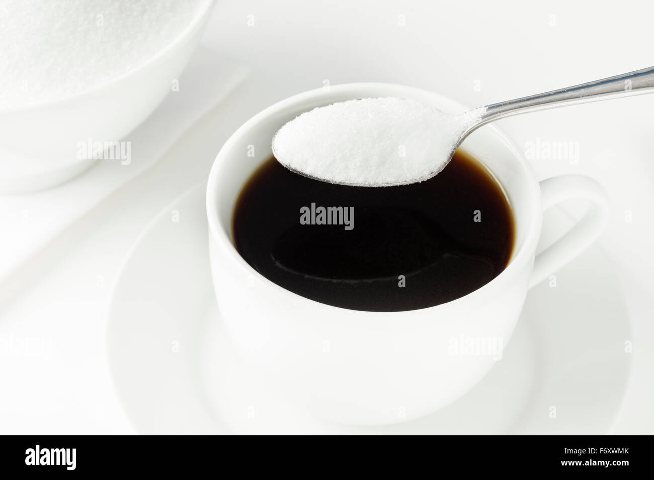 Tasse Kaffee mit Löffel voll Zucker Stockfoto