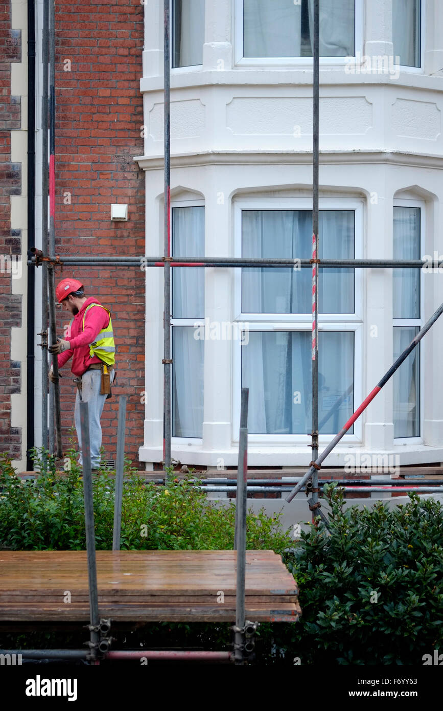 Arbeiter errichten Gerüst auf einer Haus-Fassade in England uk Stockfoto