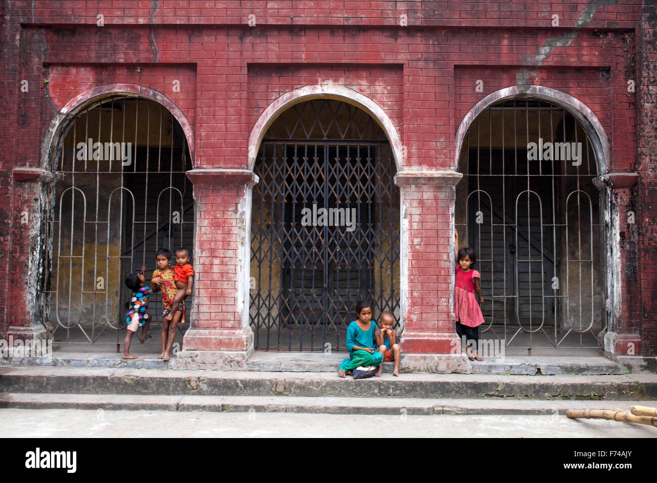 DHAKA, Bangladesch-17. November: Straßenkinder vor alten Gebäude im alten Dhaka am 17. November 2015 zu spielen. Alten Dhaka ist ein Begriff verwendet, um die historische Altstadt von der modernen Hauptstadt Dhaka beziehen. Es wurde im Jahre 1608 als Jahangir Nagar, der Hauptstadt von Mughal Bengal gegründet. Stockfoto