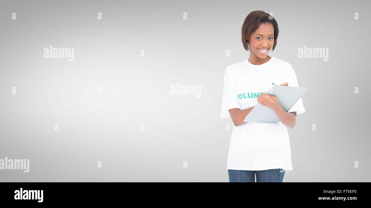Zusammengesetztes Bild lächelnd Freiwilligen Frau mit Clip-board Stockfoto