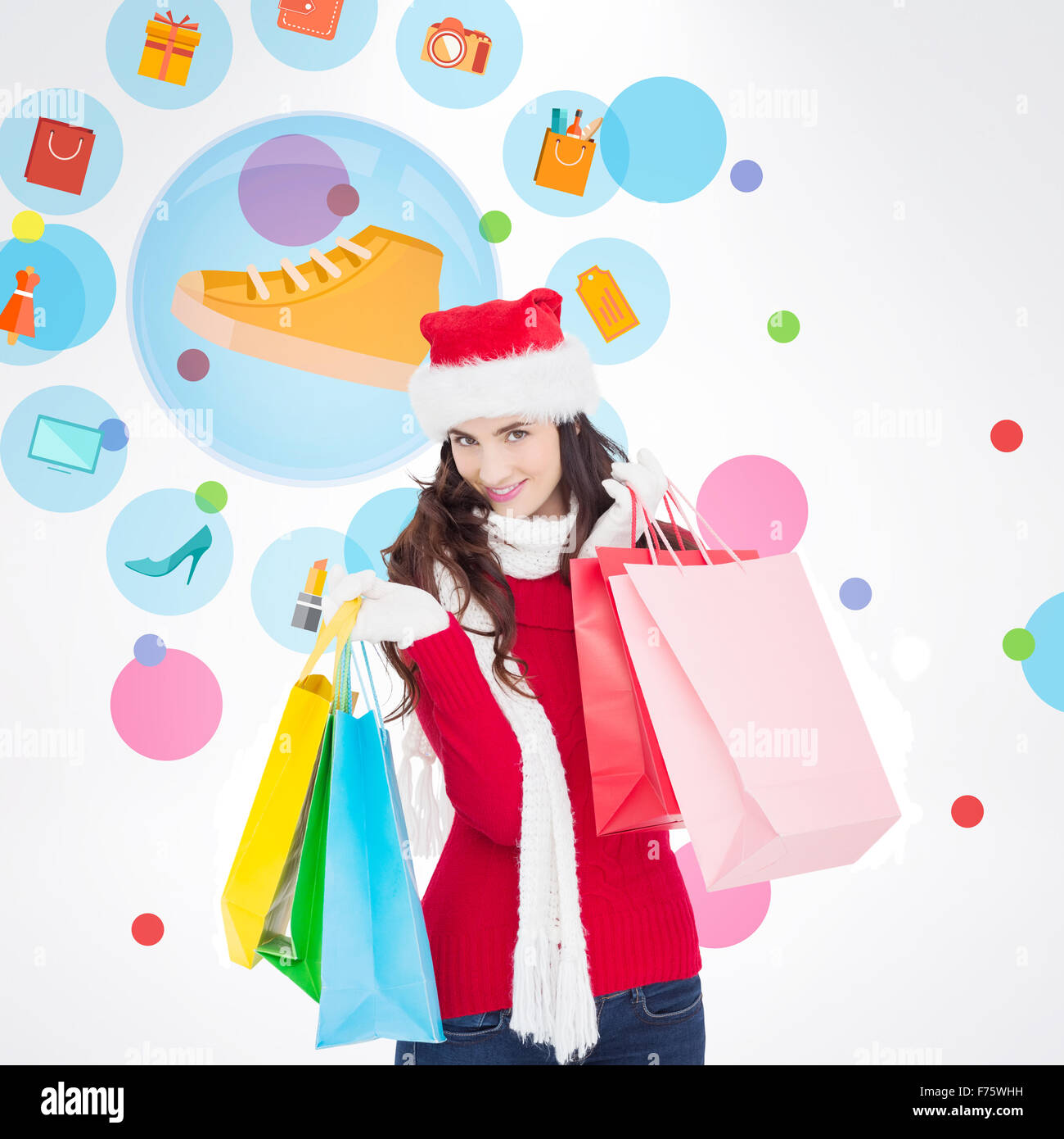 Zusammengesetztes Bild der lächelnde Brünette in Winterbekleidung holding Einkaufstaschen Stockfoto