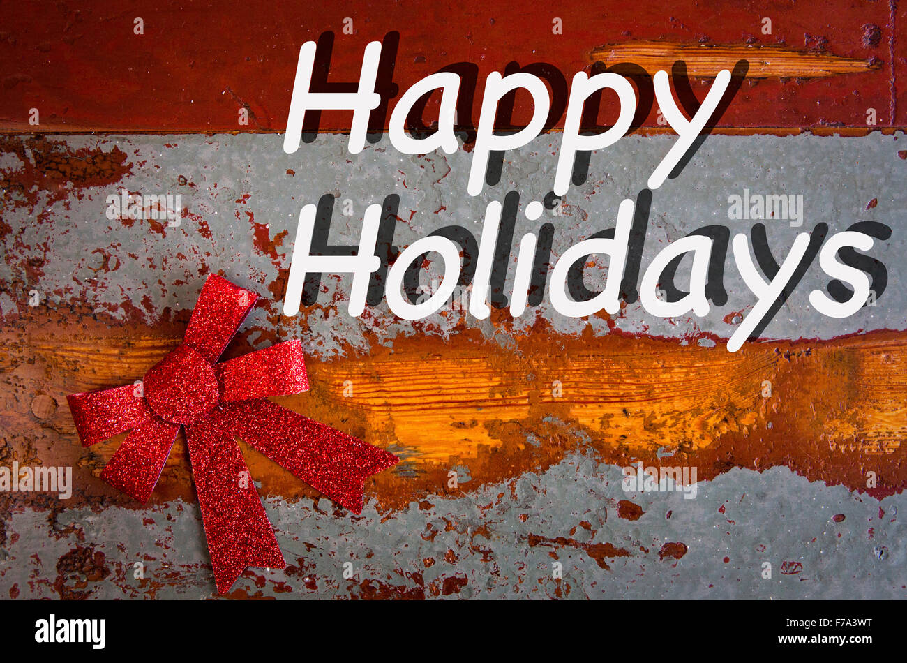"Happy Holidays" auf Vintage Holzbrett mit rotem Band Stockfoto