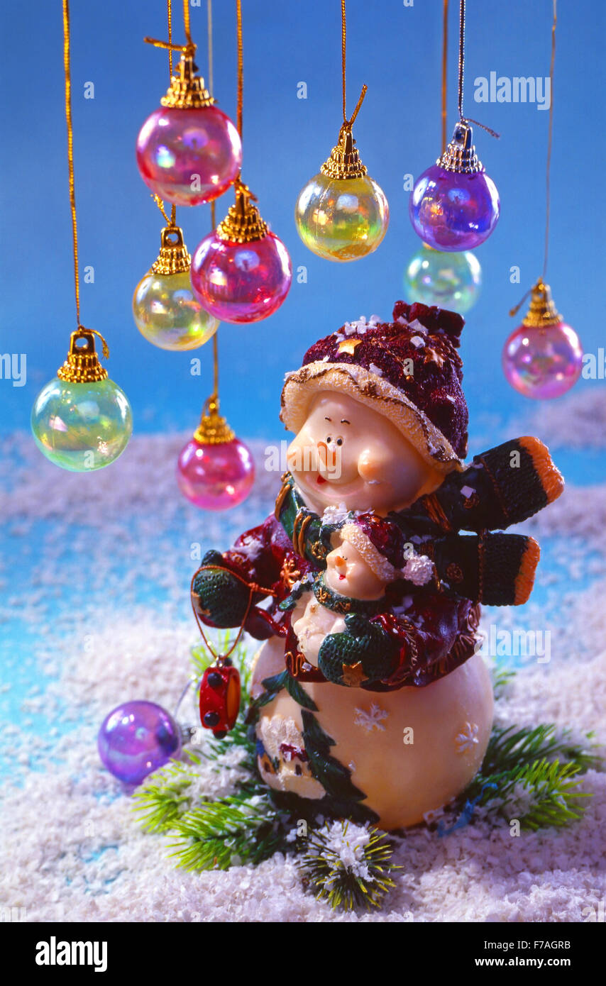 Festliches Silvester, Weihnachten Stilleben - zwei fantastische Spielzeug-Schneemänner auf Schnee mit bunten Weihnachtskugeln. Stockfoto