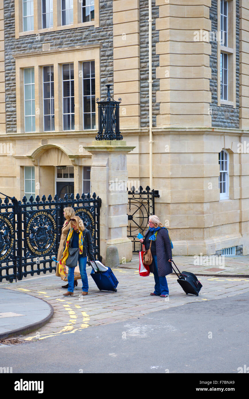 Frauen mit fahrbaren Koffer außerhalb der alten Bristol General Hospital zu Wohnungen umgebaut Stockfoto